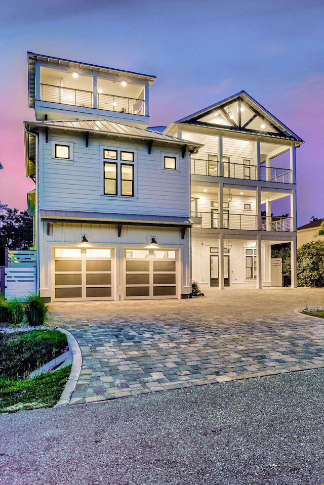 view of front of home with a garage and a balcony