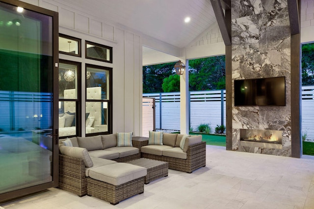 interior space with an outdoor living space with a fireplace