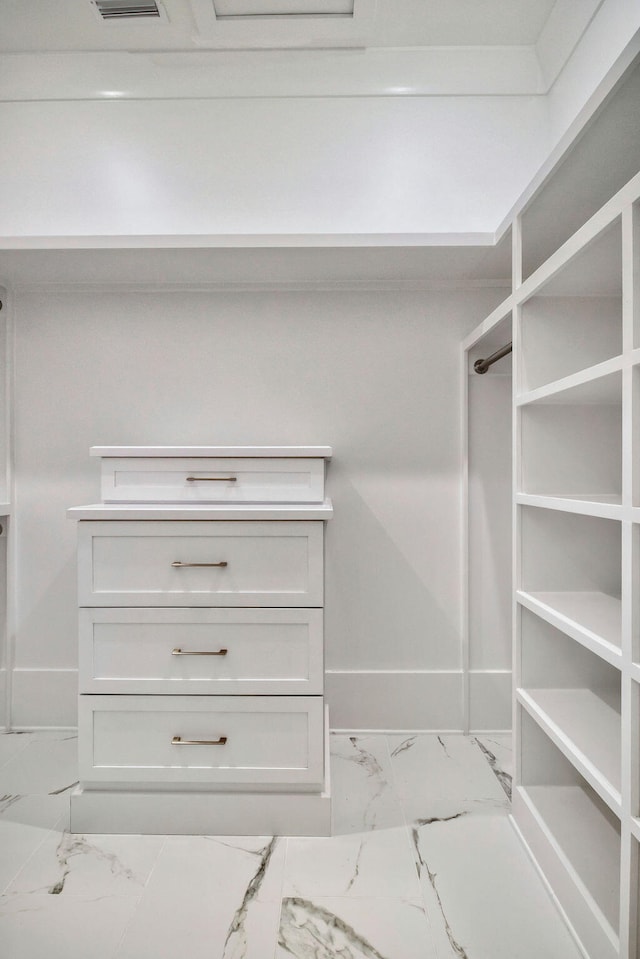 walk in closet with tile floors