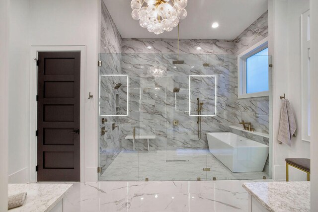 bathroom with tile walls, an enclosed shower, vanity, and a notable chandelier