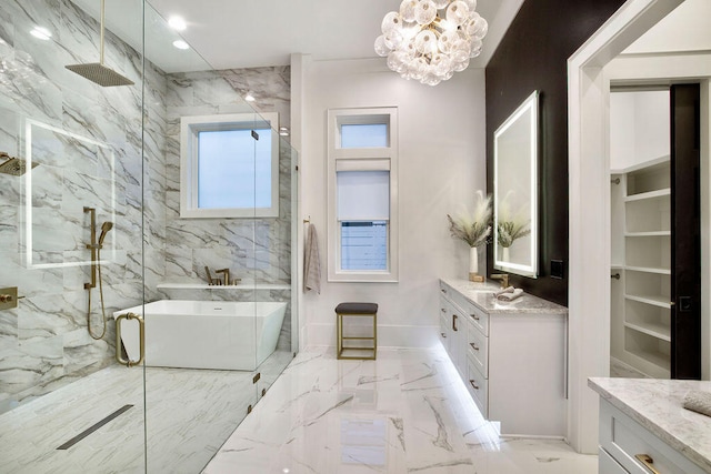 bathroom featuring a wealth of natural light, tile flooring, vanity, and a notable chandelier