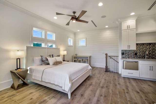 bedroom featuring light hardwood / wood-style flooring and ceiling fan