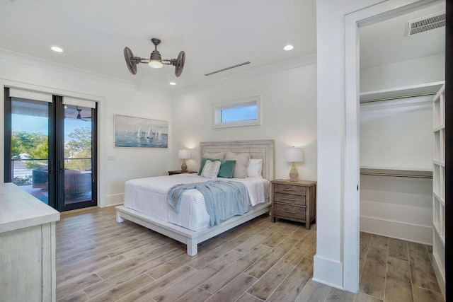 bedroom with french doors, ornamental molding, light hardwood / wood-style floors, and access to exterior