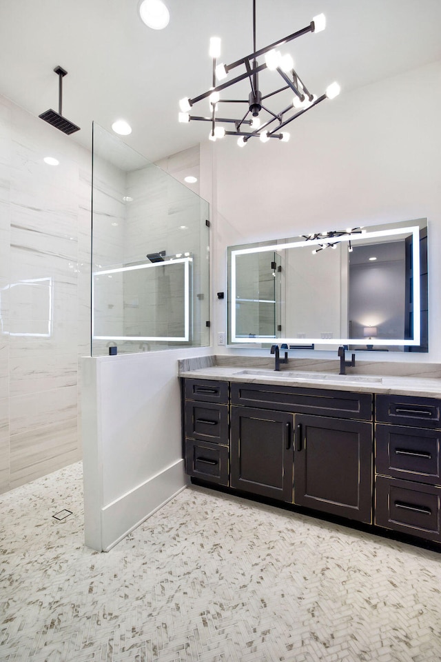 bathroom featuring walk in shower, vanity, and a chandelier