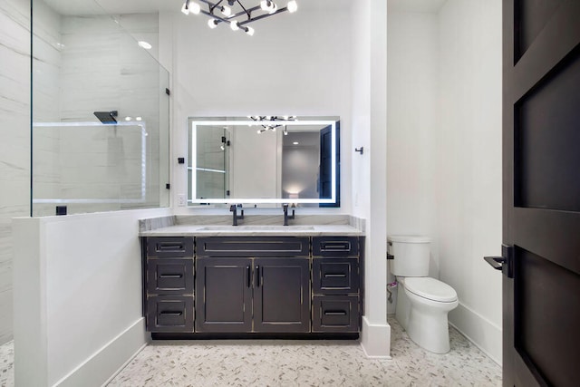 bathroom with an inviting chandelier, toilet, vanity, and a shower with door