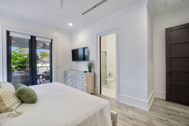 bedroom with ensuite bath, light hardwood / wood-style floors, and access to exterior