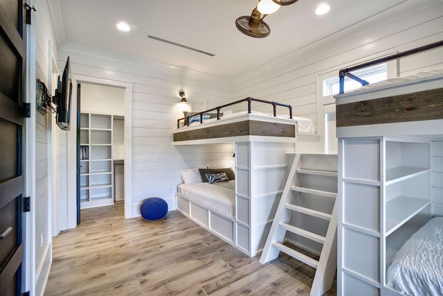 mudroom with wooden walls and light wood-type flooring