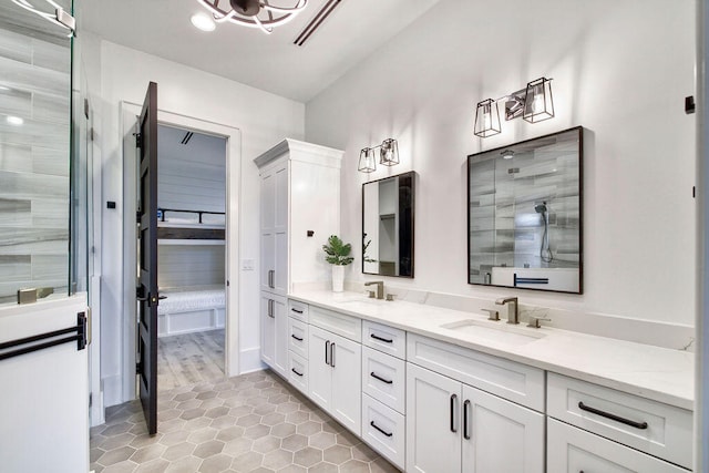 bathroom with vanity with extensive cabinet space, double sink, and tile flooring