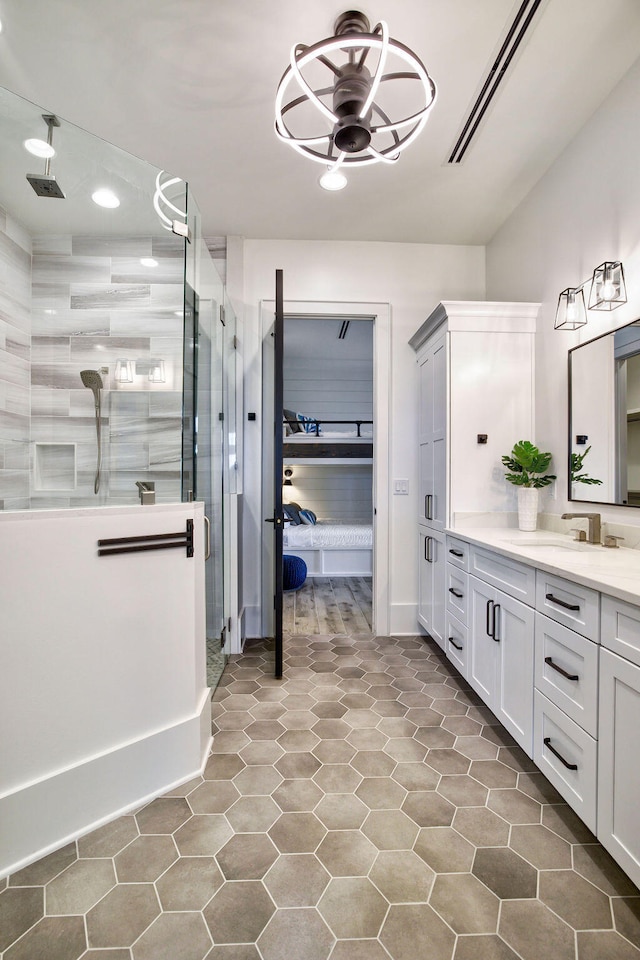 bathroom with tile flooring, walk in shower, ceiling fan, and large vanity