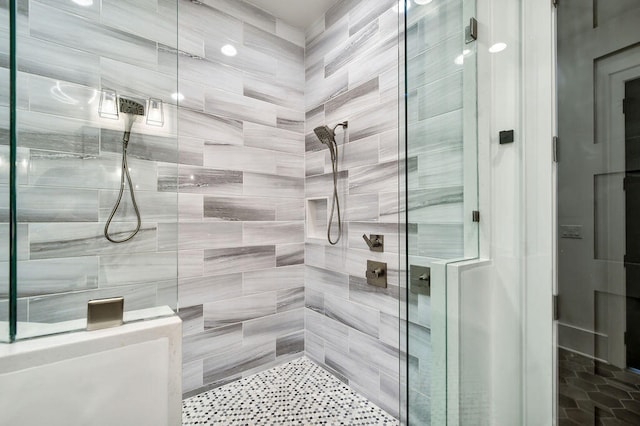 bathroom featuring a shower with shower door