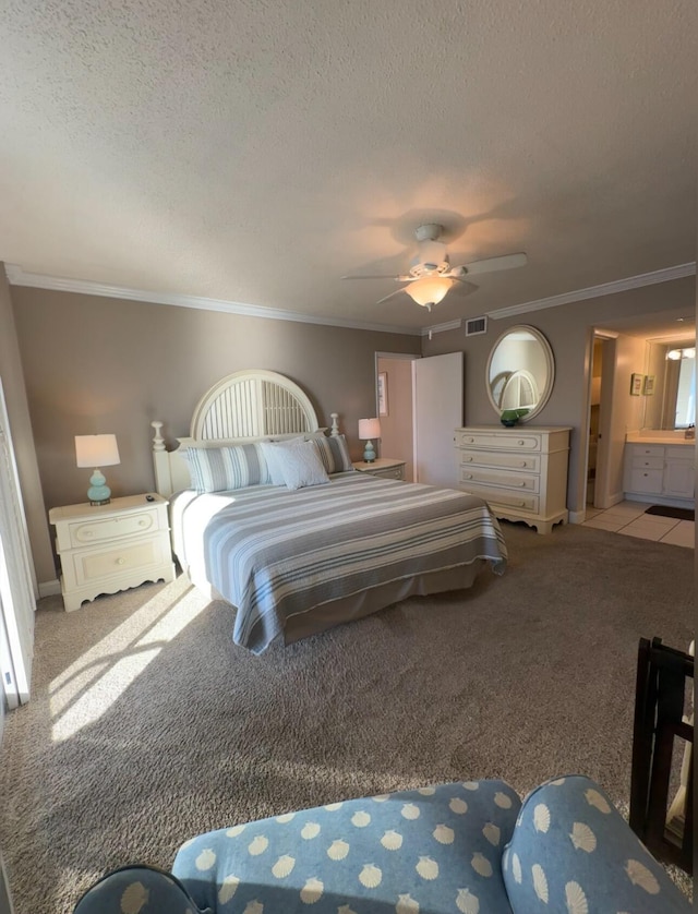 carpeted bedroom featuring ornamental molding, ceiling fan, and a textured ceiling