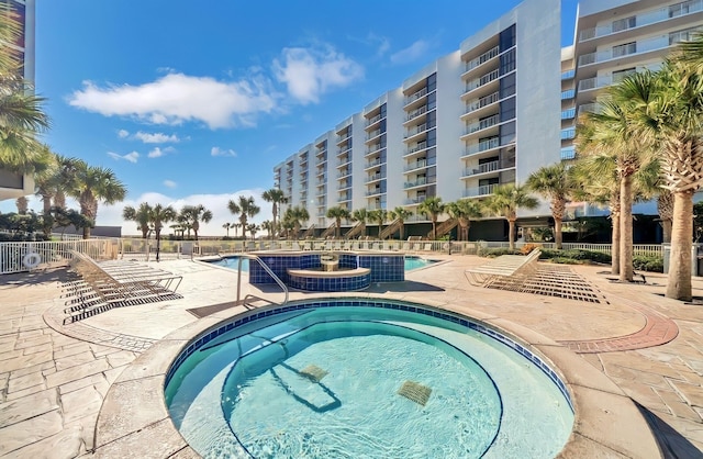 view of pool with a community hot tub