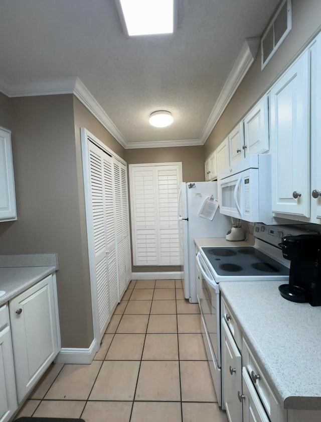 kitchen featuring white cabinetry, crown molding, white appliances, and light tile floors