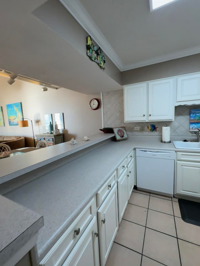 kitchen featuring light tile floors, white cabinets, sink, dishwasher, and backsplash