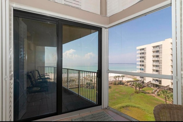 sunroom / solarium with a water view