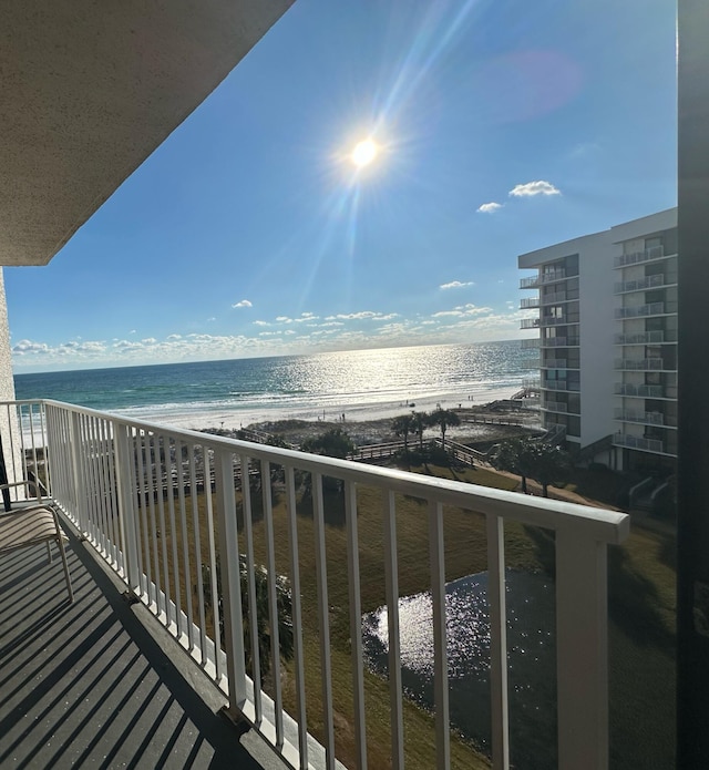 balcony with a beach view and a water view