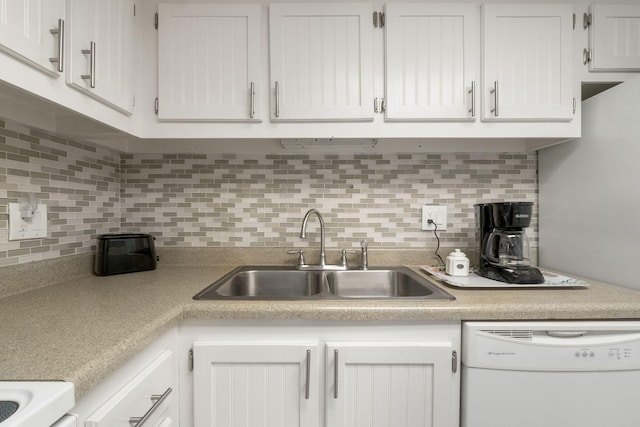 kitchen featuring white cabinets, sink, dishwasher, and backsplash