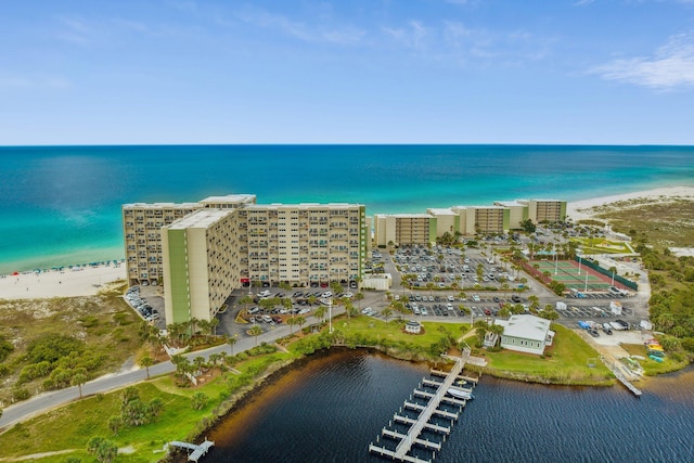 birds eye view of property featuring a beach view and a water view