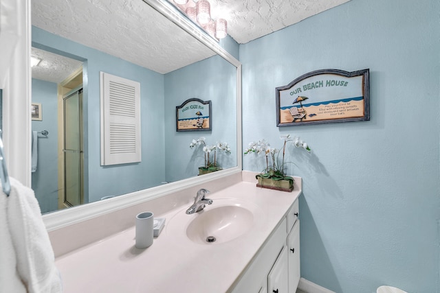 bathroom with a textured ceiling and oversized vanity