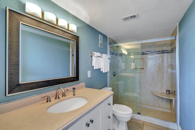 bathroom with tile flooring, a textured ceiling, an enclosed shower, toilet, and vanity