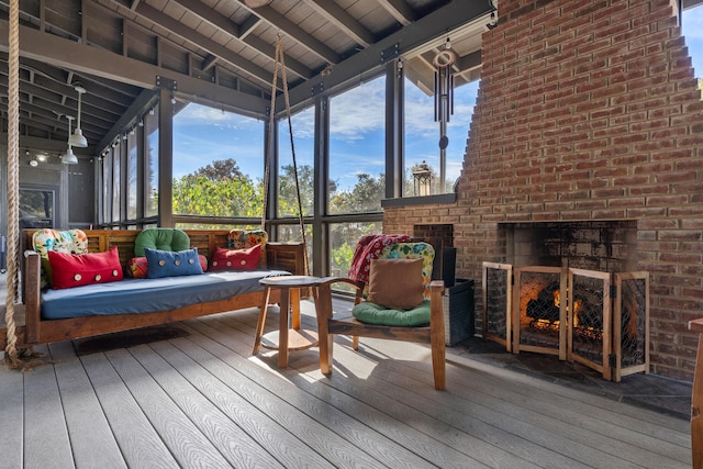 sunroom / solarium featuring a wealth of natural light, lofted ceiling with beams, and wood ceiling