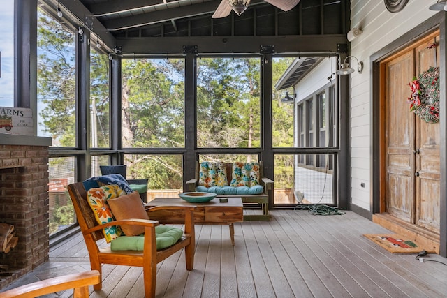 sunroom / solarium featuring ceiling fan and lofted ceiling