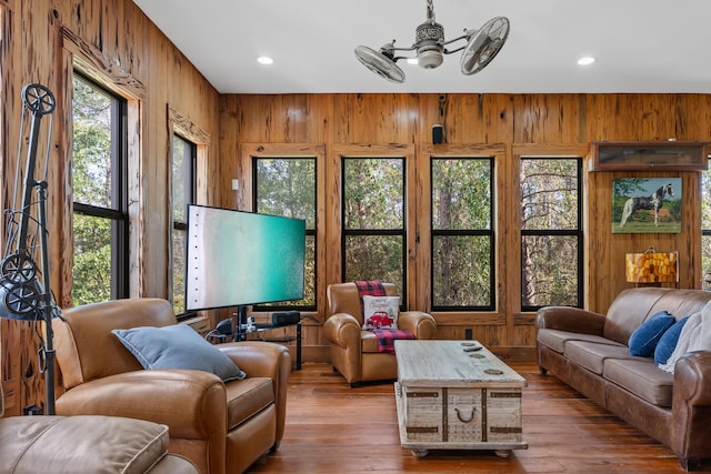 living room with a wealth of natural light, hardwood / wood-style floors, and ceiling fan