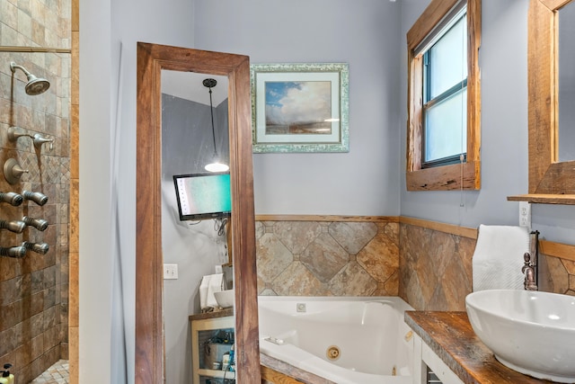 bathroom with vanity and a tile shower