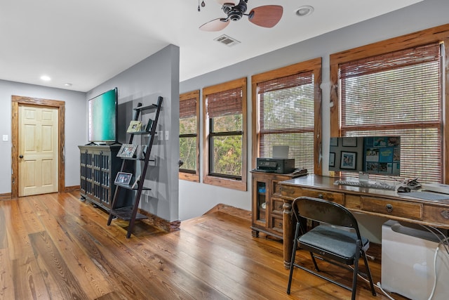 home office with ceiling fan and light wood-type flooring