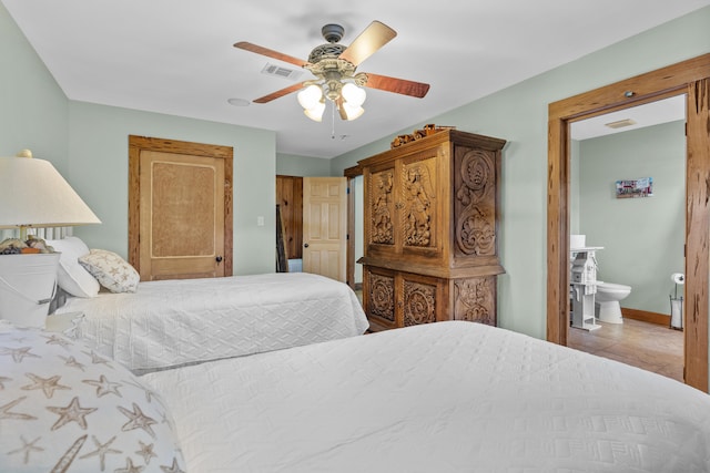 tiled bedroom featuring ceiling fan and ensuite bathroom