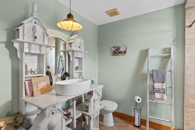 bathroom with vanity, tile floors, and toilet