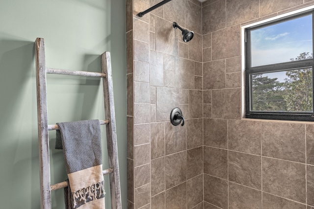 bathroom with tiled shower