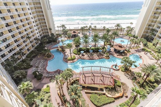 birds eye view of property featuring a water view and a beach view