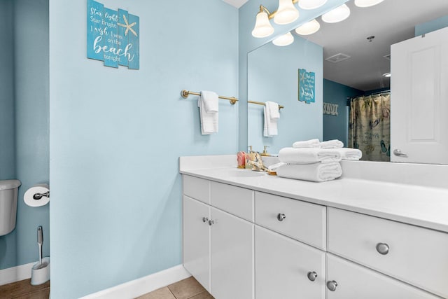 bathroom with curtained shower, tile patterned flooring, vanity, and toilet