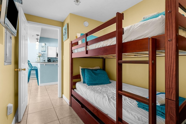 bedroom featuring light tile patterned floors and baseboards