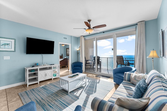 living room with ceiling fan and light tile patterned floors