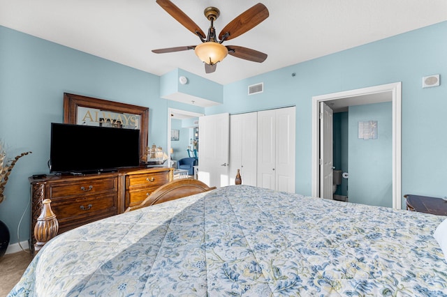 carpeted bedroom featuring a closet and ceiling fan