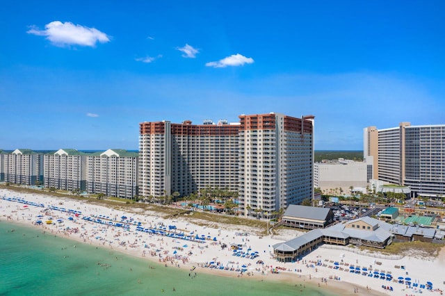 aerial view featuring a water view, a view of city, and a beach view