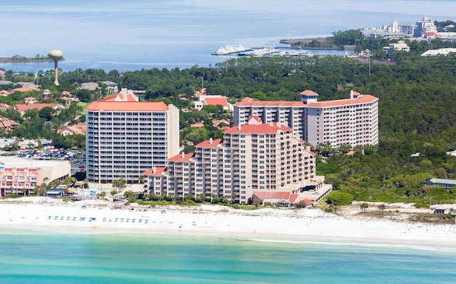 bird's eye view featuring a water view and a beach view