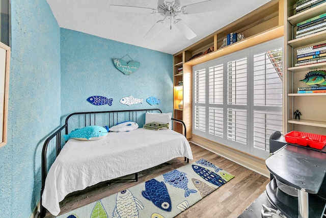 bedroom featuring ceiling fan and hardwood / wood-style flooring