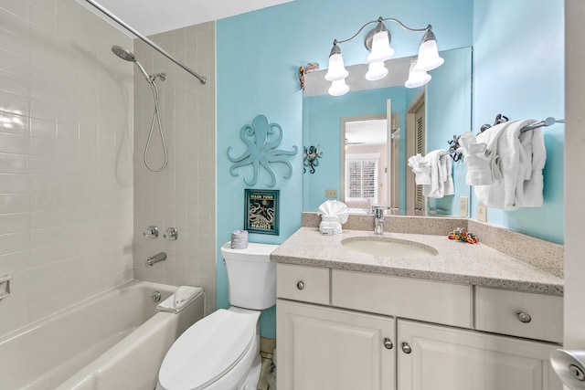 full bathroom featuring tiled shower / bath combo, oversized vanity, and toilet