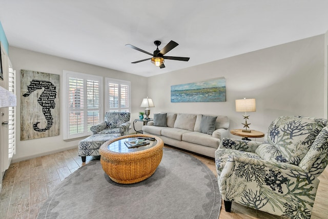 living room with light hardwood / wood-style flooring and ceiling fan