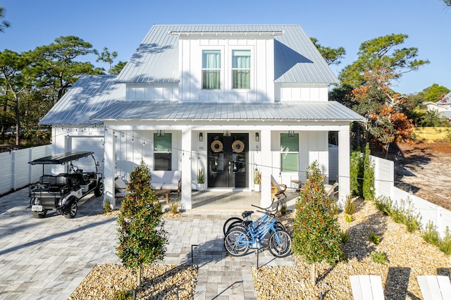 rear view of house featuring covered porch