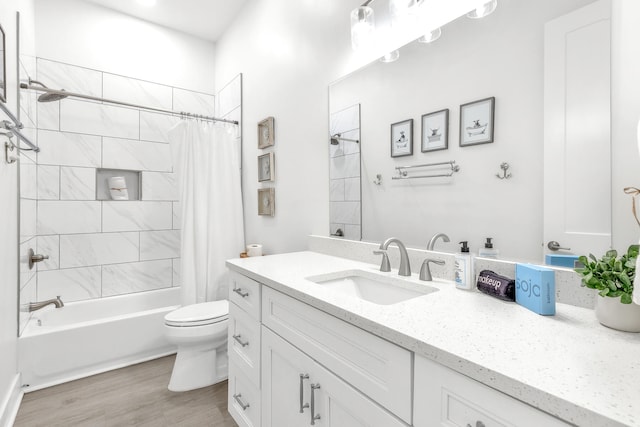 full bathroom with toilet, oversized vanity, shower / bath combination with curtain, and hardwood / wood-style floors