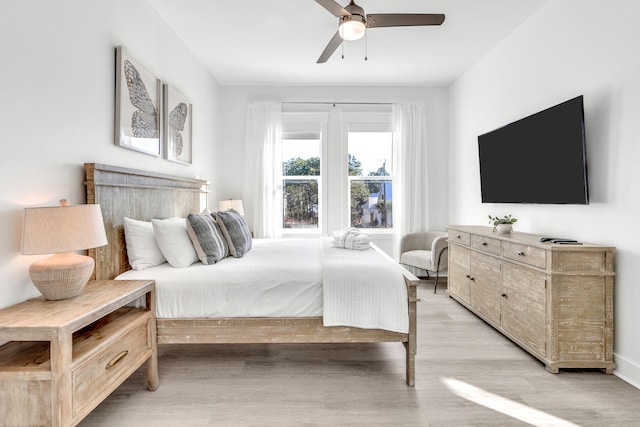 bedroom with light hardwood / wood-style floors and ceiling fan