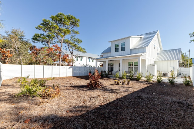 back of house featuring a porch