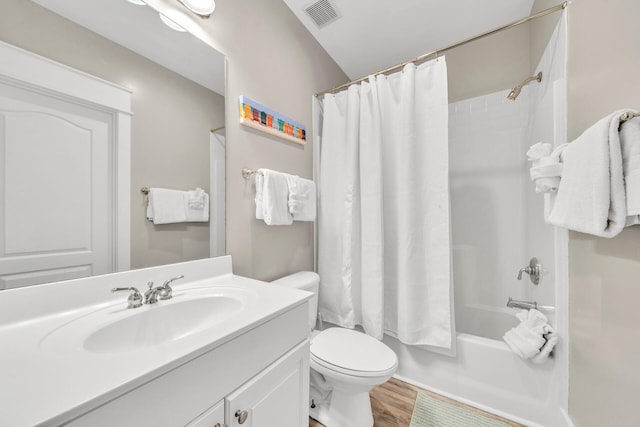 full bathroom featuring wood-type flooring, oversized vanity, shower / bath combination with curtain, and toilet