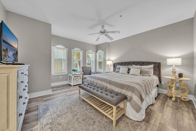 bedroom with light hardwood / wood-style flooring and ceiling fan