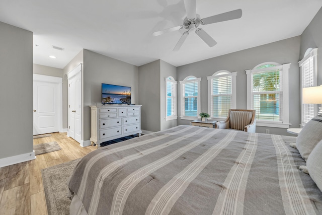 bedroom with ceiling fan and light wood-type flooring