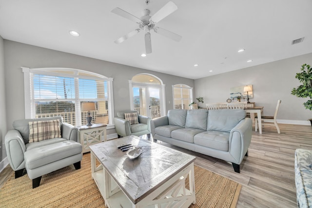 living room with french doors, light hardwood / wood-style floors, and ceiling fan